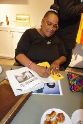 Mama Ali signing books at a Luxury Chamber Media Group Event